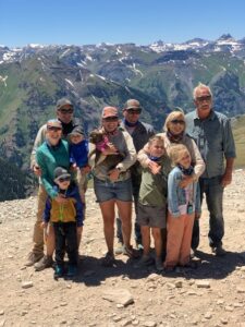 Storm family including three generations standing together on a mountain top.