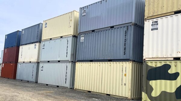 Steel shipping containers of multiple colors stacked three high