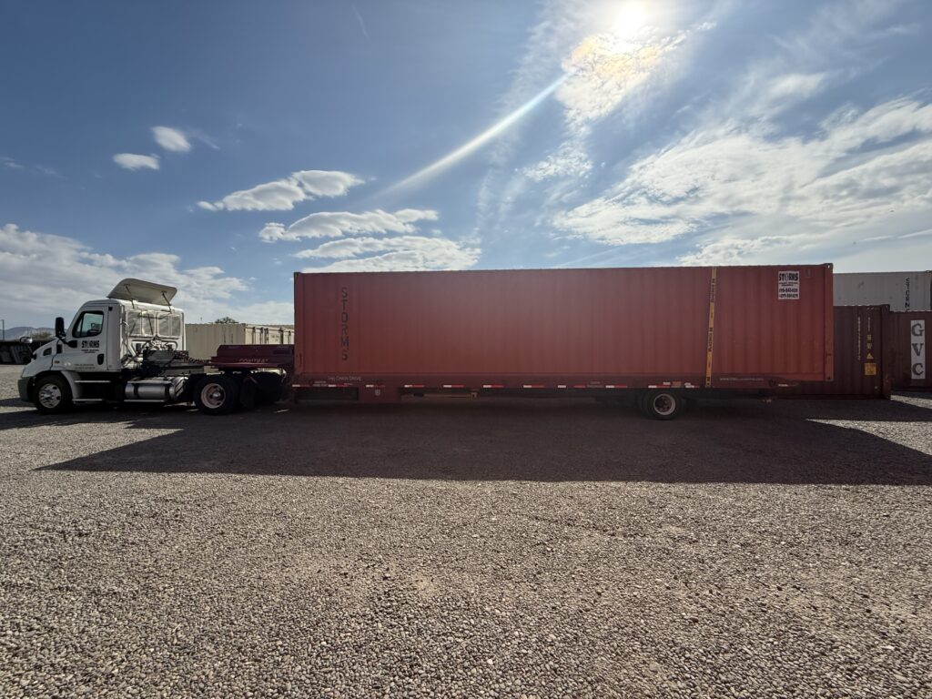 Shipping container on delivery trailer being hauled by a semi truck.