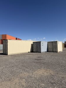 Three shipping containers beside each other with three different sizes.