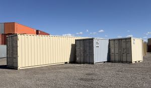 Three shipping containers beside each other with three different sizes.